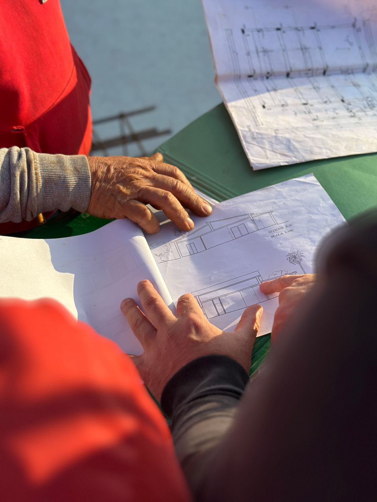Architects reviewing construction blueprints at a job site