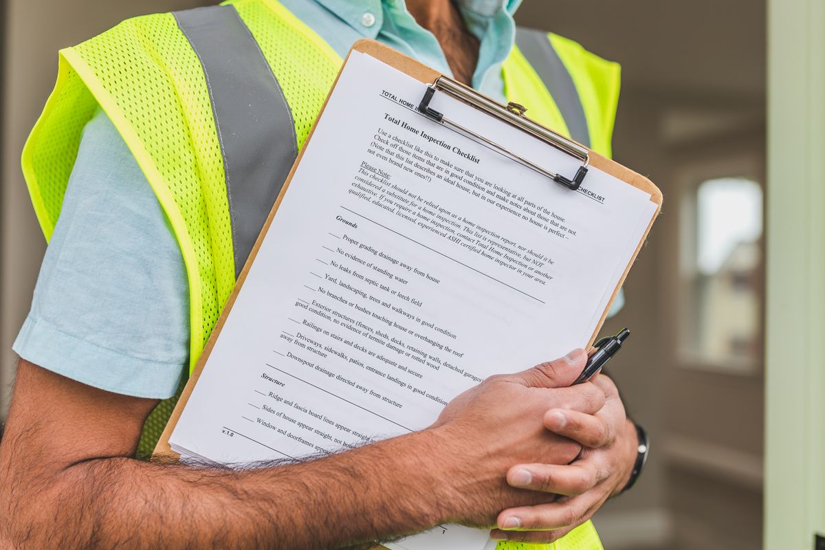 Building inspector completing a safety and quality checklist