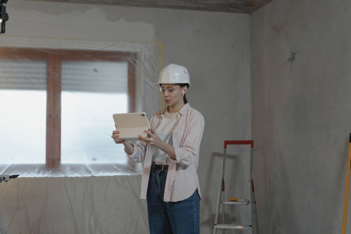 Field engineer using a tablet inside an active construction project