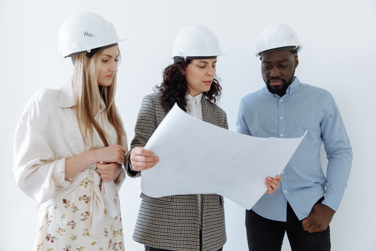 Contractors coordinating around a large construction plan